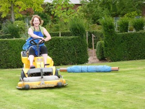 Using lawn mower to help roll a fleece